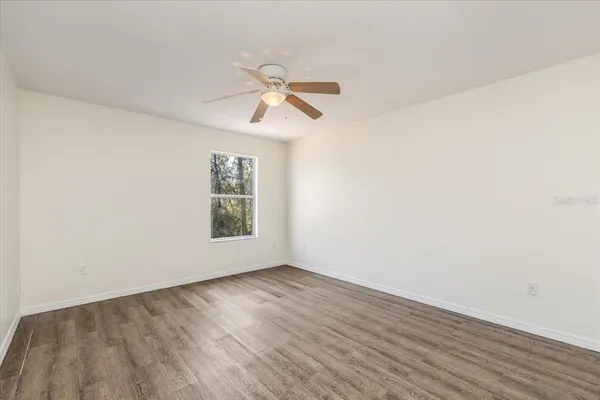 a view of an empty room and wooden floor