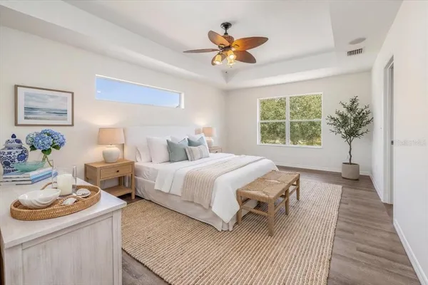 a bedroom with a bed and a chandelier