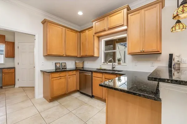 a kitchen with stainless steel appliances granite countertop a refrigerator stove and microwave