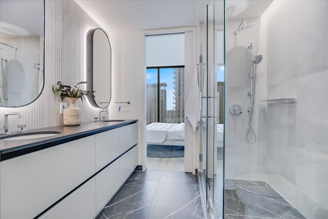 610 Davis Street, Unit 3002 Austin, TX 78701 - Photo 11 of 31 a bathroom with a double vanity sink mirror and shower
