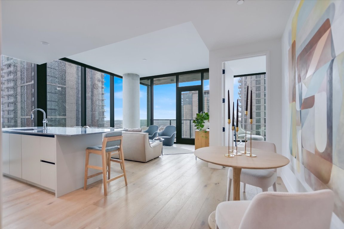 610 Davis Street, Unit 3002 Austin, TX 78701 - Photo 2 of 31 a living room with fireplace furniture and a table
