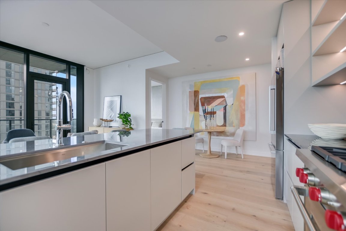 610 Davis Street, Unit 3002 Austin, TX 78701 - Photo 4 of 31 a dining hall with granite countertop a large counter space and a sink