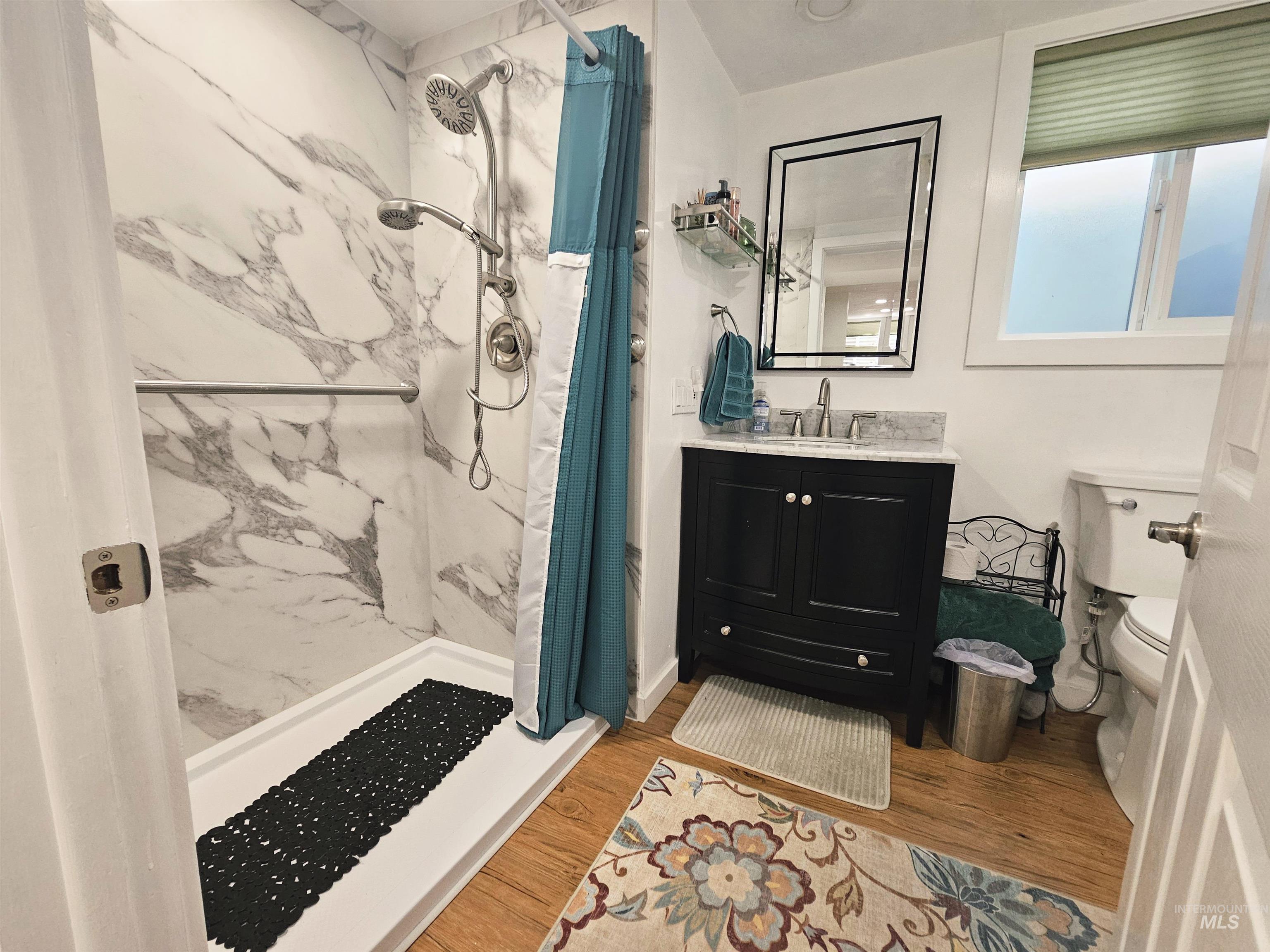 712 3rd Street Lewiston, ID 83501 - Photo 19 of 30 Bathroom with vanity, a marble finish shower, and light wood-style floors