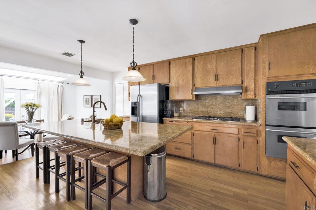 536 Hampton Road Burbank, CA 91504 - Photo 13 of 42 a kitchen with granite countertop a table chairs stove and cabinets