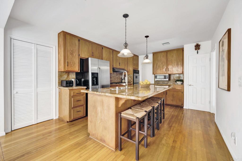 536 Hampton Road Burbank, CA 91504 - Photo 14 of 42 a kitchen with stainless steel appliances kitchen island granite countertop a table chairs and a refrigerator