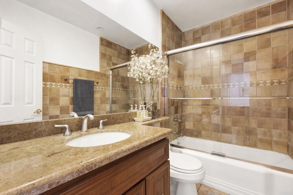 536 Hampton Road Burbank, CA 91504 - Photo 21 of 42 a bathroom with a granite countertop sink a toilet a mirror and shower