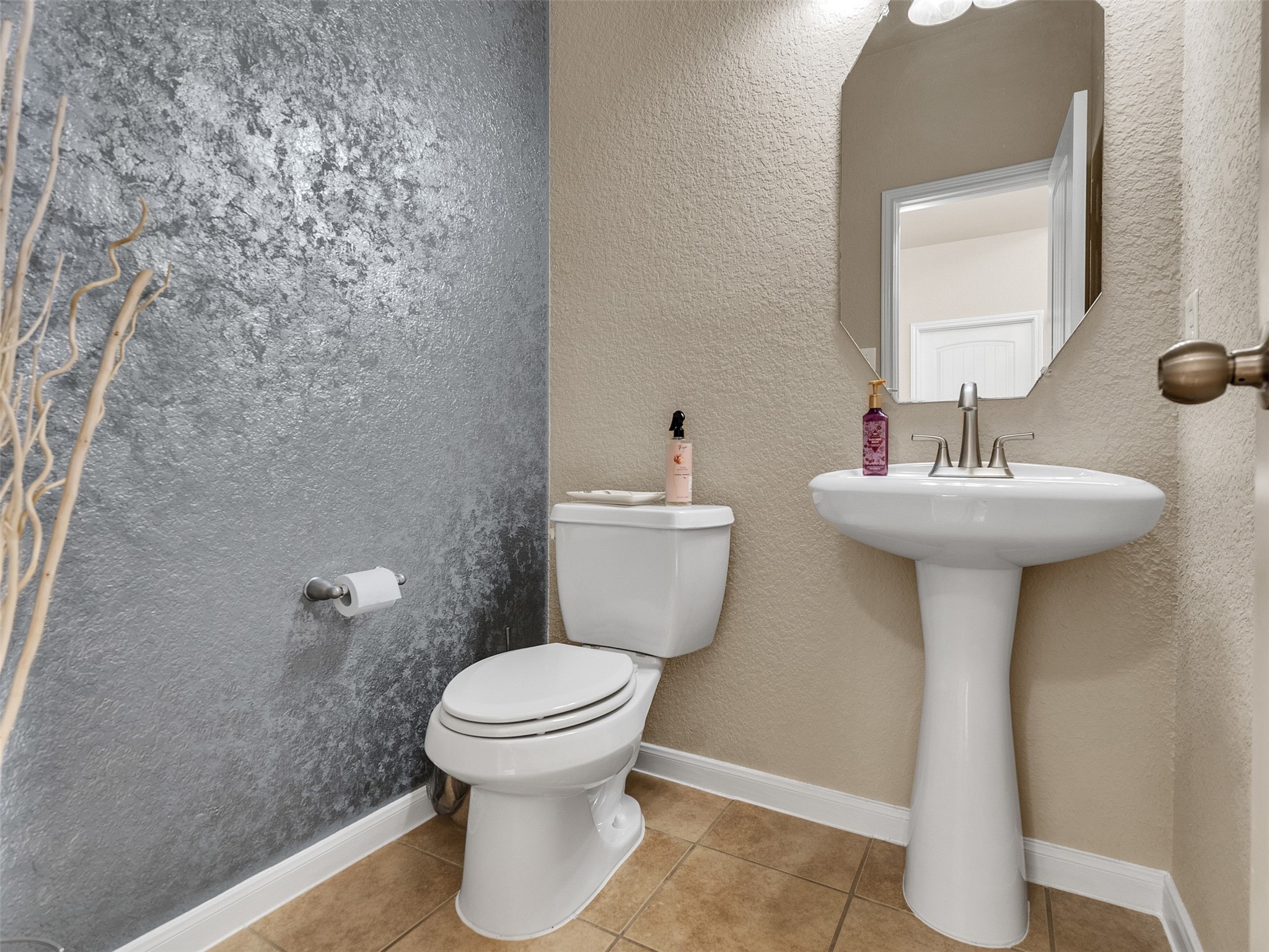 522 Summer Mist Lane Rosenberg, TX 77469 - Photo 9 of 36 This powder room features a bold, contemporary design with a striking metallic accent wall that adds texture and light-reflective depth to the space.