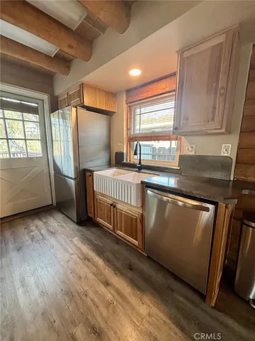 a kitchen with stainless steel appliances granite countertop a sink and a stove