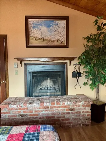 a living room with a fireplace and potted plant