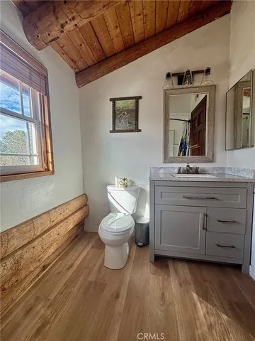 a bathroom with a sink mirror and toilet