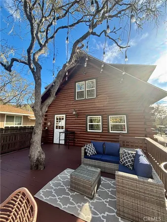 a view of a patio with table and chairs and wooden fence