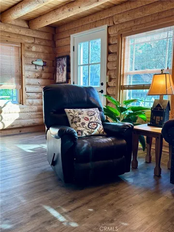a living room with furniture a window and a fireplace