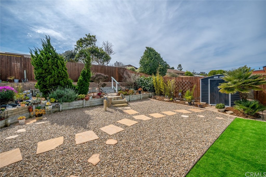 765 Lilac Drive Los Osos, CA 93402 - Photo 15 of 54 a row of palm trees in front of a house