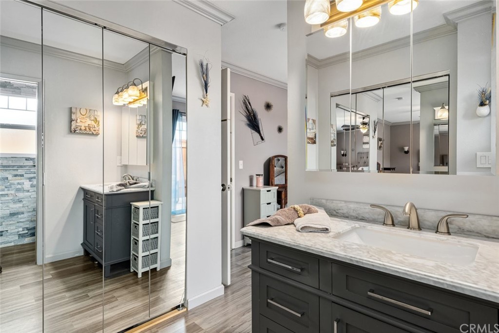 765 Lilac Drive Los Osos, CA 93402 - Photo 26 of 54 a bathroom with a granite countertop sink a mirror a vanity and shower