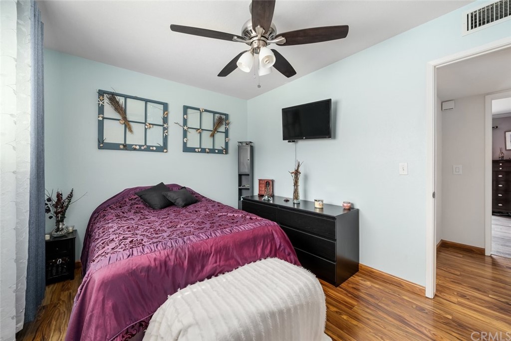 765 Lilac Drive Los Osos, CA 93402 - Photo 30 of 54 a bedroom with a bed and a flat screen tv