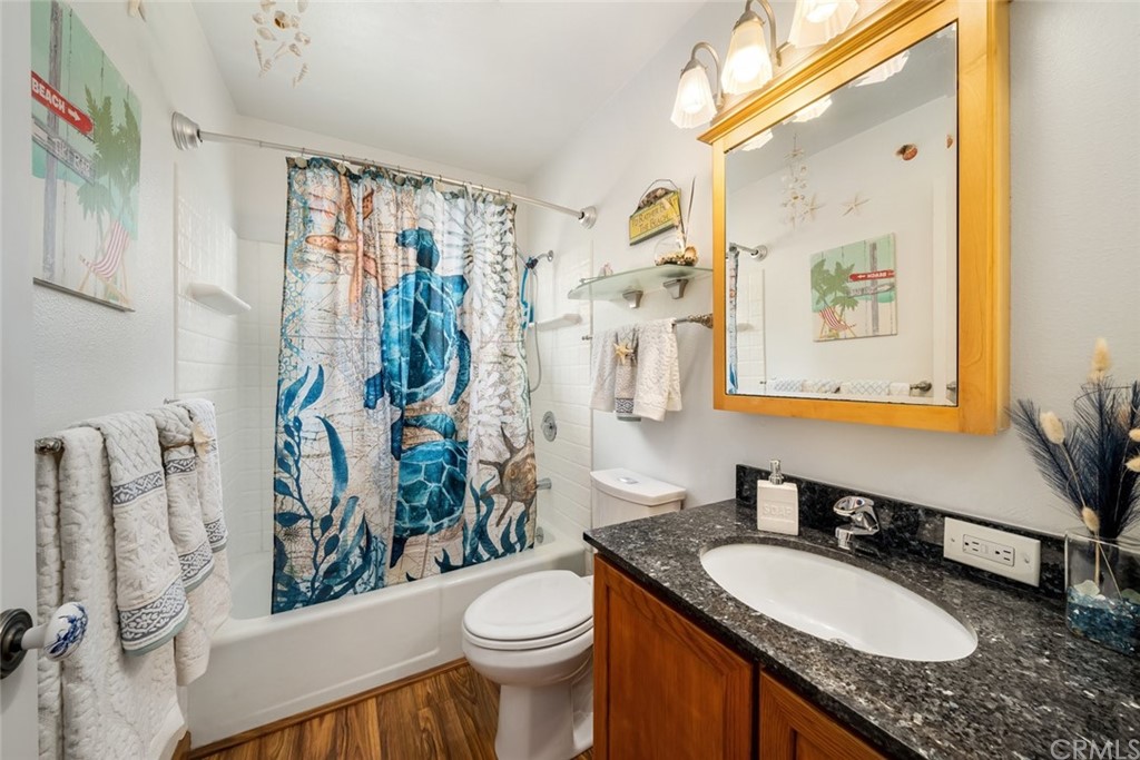 765 Lilac Drive Los Osos, CA 93402 - Photo 32 of 54 a bathroom with a granite countertop sink mirror vanity and toilet