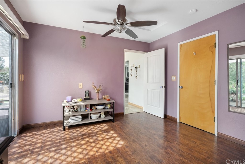 765 Lilac Drive Los Osos, CA 93402 - Photo 34 of 54 a view of a livingroom with wooden floor and a ceiling fan