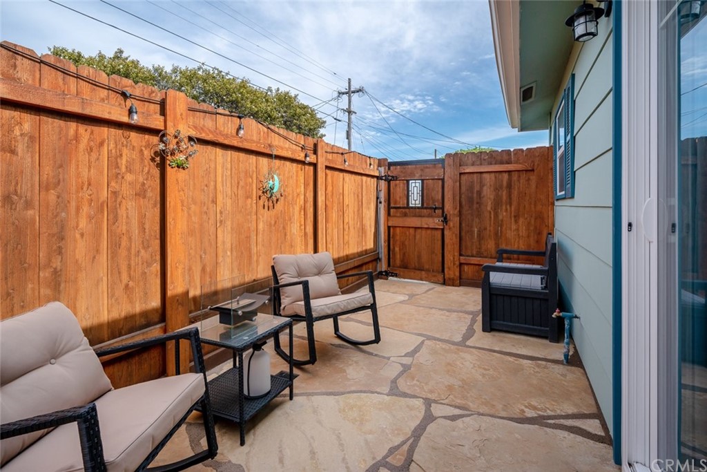 765 Lilac Drive Los Osos, CA 93402 - Photo 36 of 54 a backyard of a house with barbeque oven table and chairs