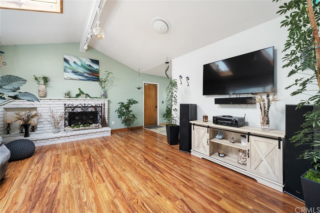 765 Lilac Drive Los Osos, CA 93402 - Photo 5 of 54 a living room with furniture a flat screen tv and a fireplace
