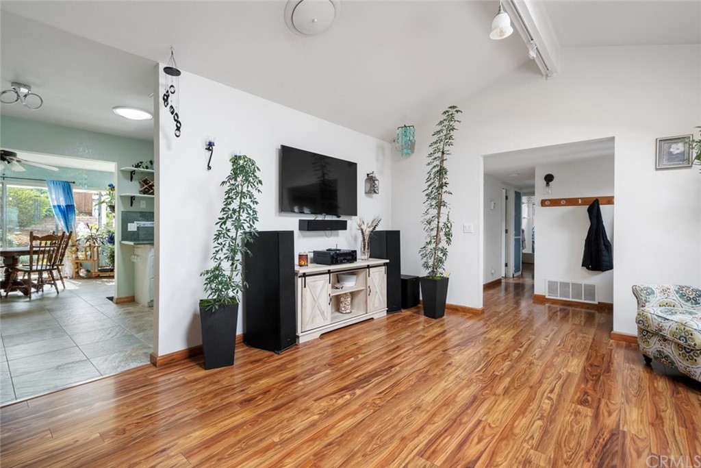 765 Lilac Drive Los Osos, CA 93402 - Photo 7 of 54 a kitchen with a refrigerator and a flat screen tv