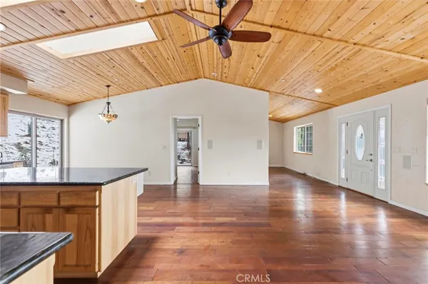a hallway with wooden floor and windows
