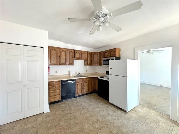 a kitchen with stainless steel appliances a refrigerator sink and stove