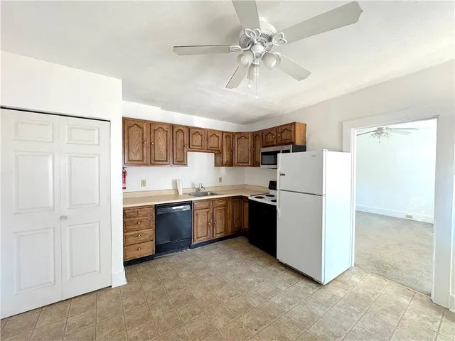 a kitchen with stainless steel appliances a refrigerator sink and stove