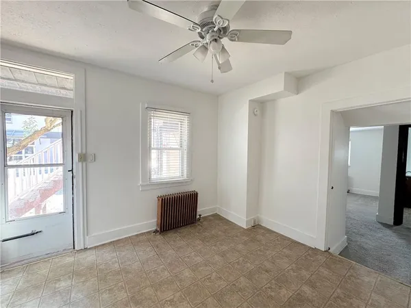 a view of livingroom with furniture ceiling fan and window