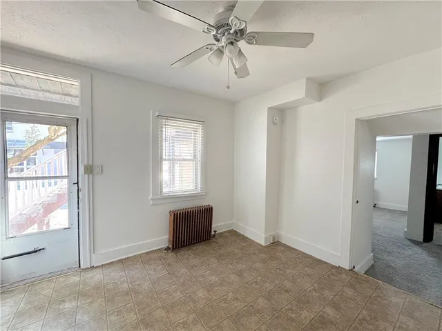 a view of livingroom with furniture ceiling fan and window