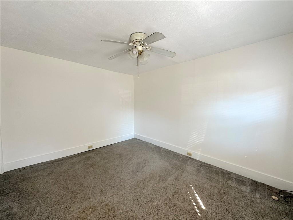 30 South 13th Street Pittsburgh, PA 15203 - Photo 8 of 13 an empty room with a chandelier fan and windows
