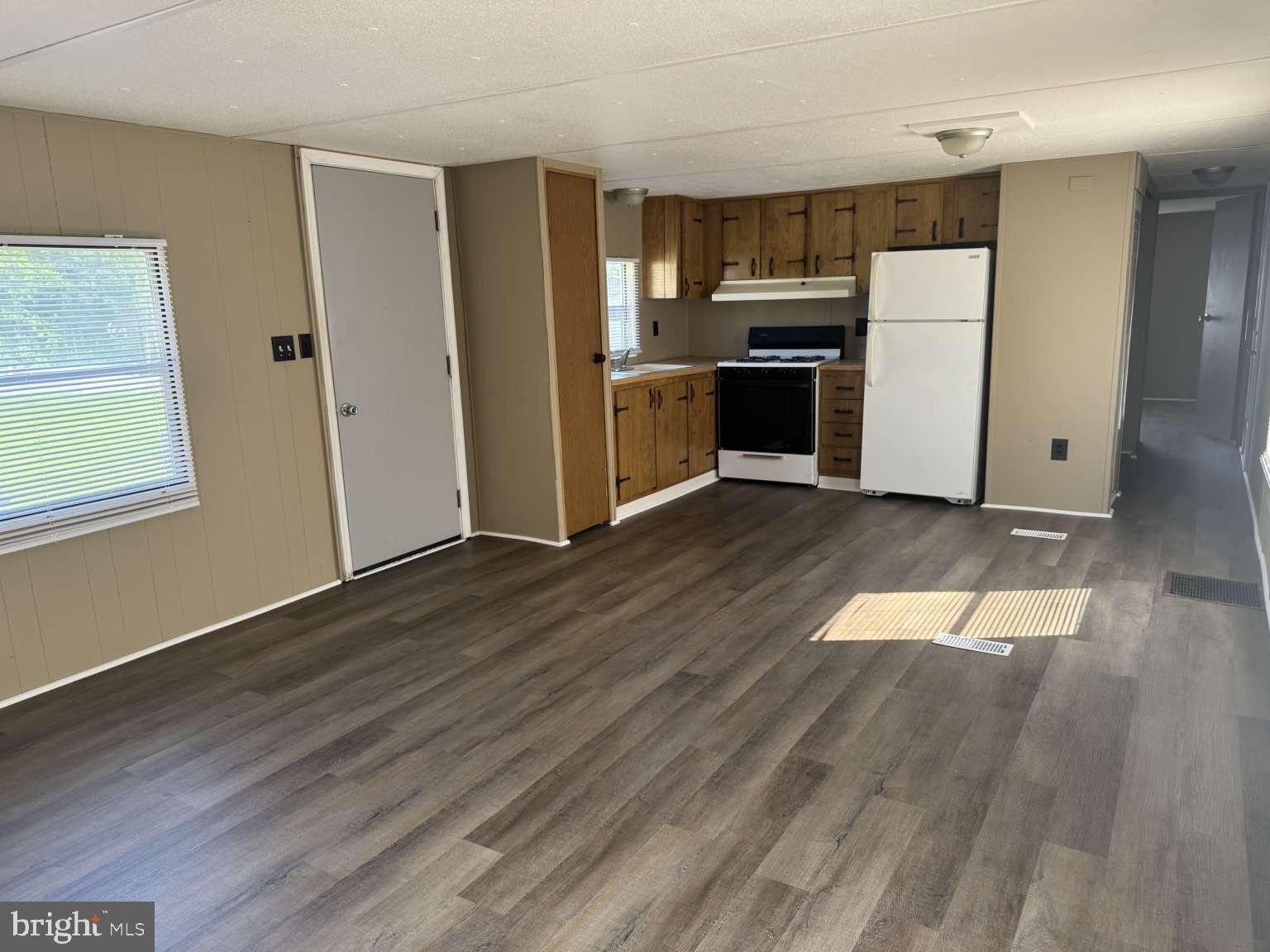 3720 Davidsburg Road Dover, PA 17315 - Photo 5 of 25 an empty room with wooden floor kitchen view and windows