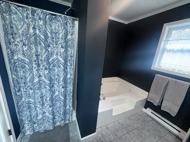 a bathroom with a toilet and a shower curtain