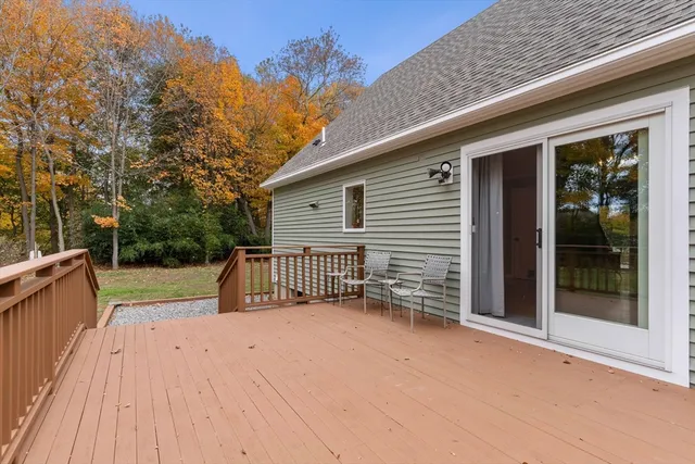 a view of backyard with deck and trees