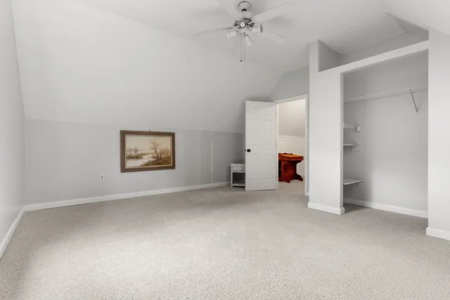 an empty room with a ceiling fan and bathroom