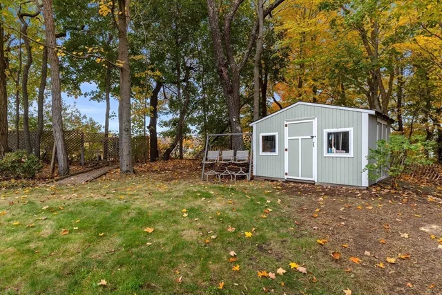 a view of a house with backyard and sitting area