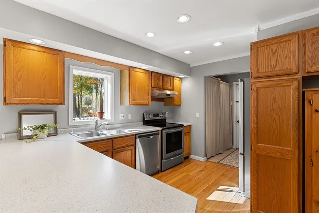 a kitchen with stainless steel appliances granite countertop a refrigerator and a sink