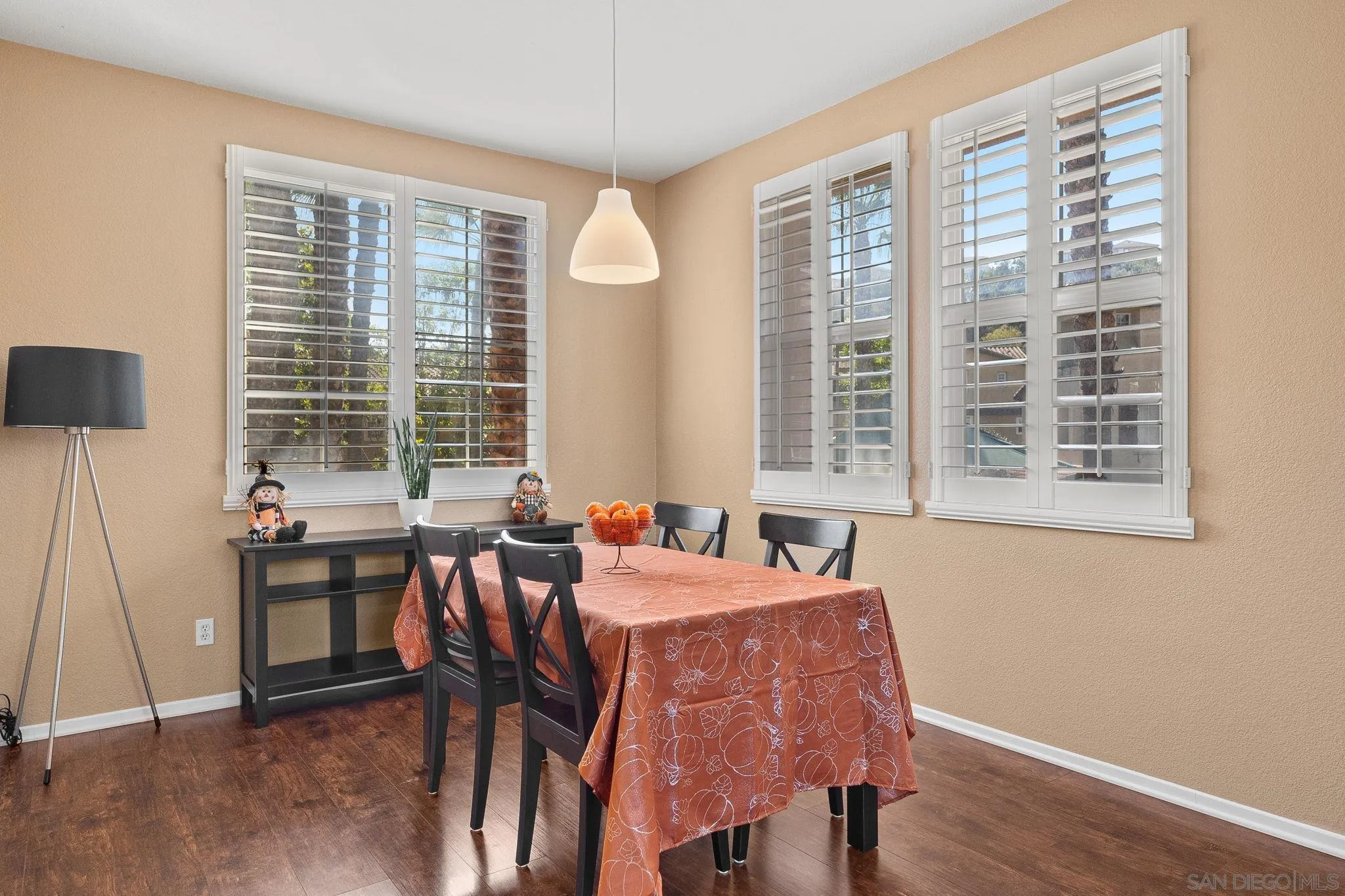 812 Compass Way San Diego, CA 92154 - Photo 11 of 39 a view of a dining room with furniture windows and wooden floor