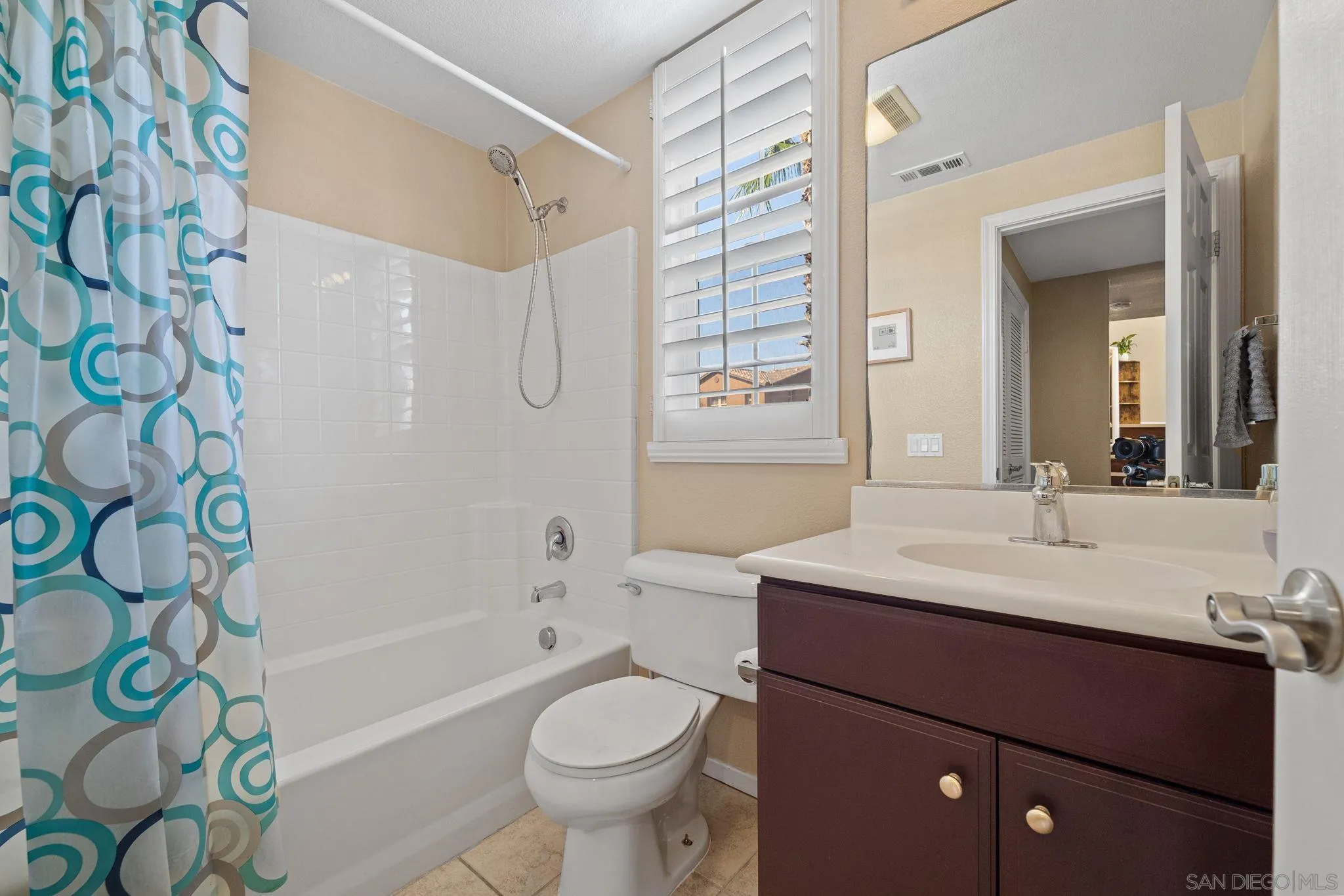 812 Compass Way San Diego, CA 92154 - Photo 19 of 39 a bathroom with a sink toilet a mirror and shower