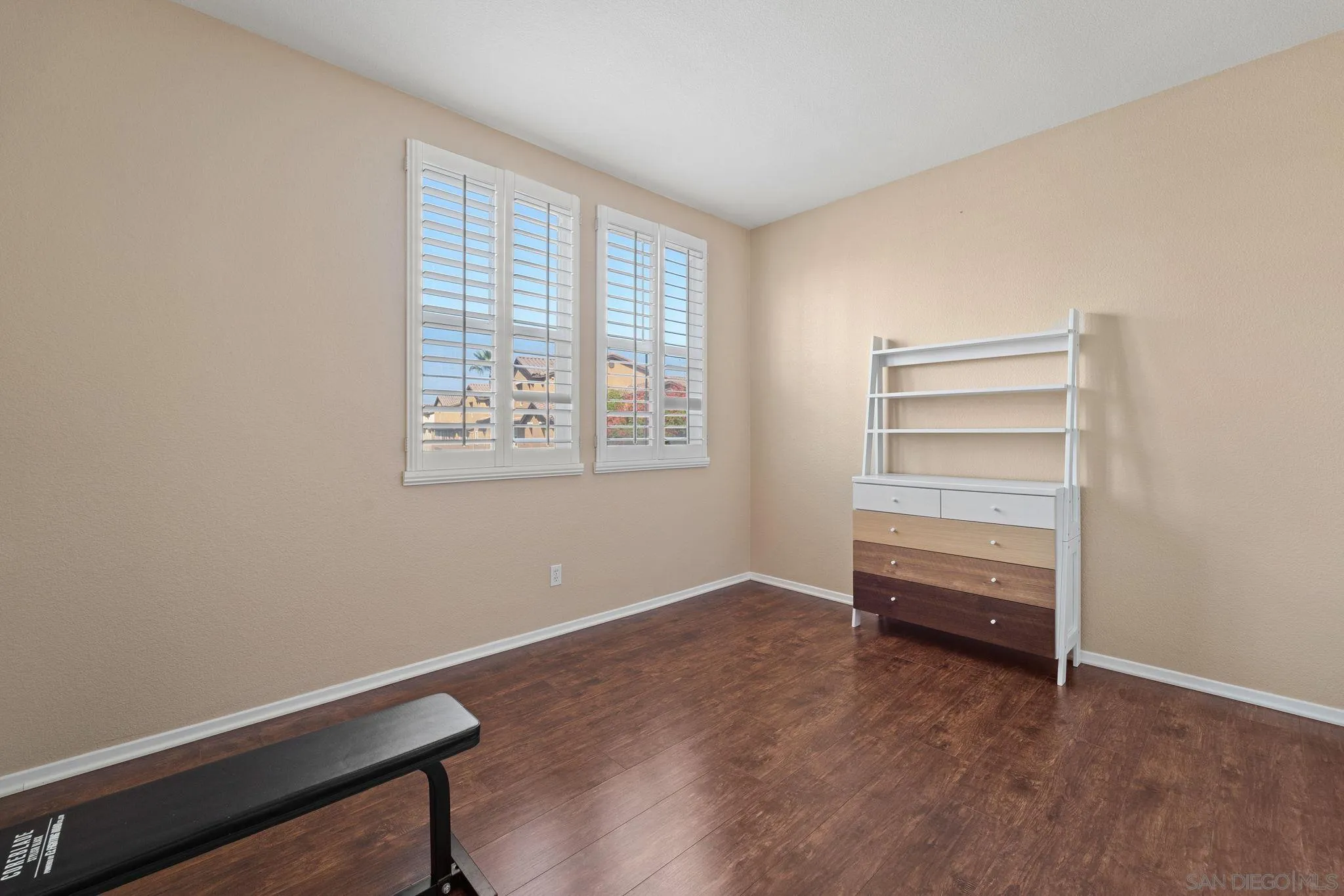 812 Compass Way San Diego, CA 92154 - Photo 20 of 39 a view of room with hardwood floor and cabinet