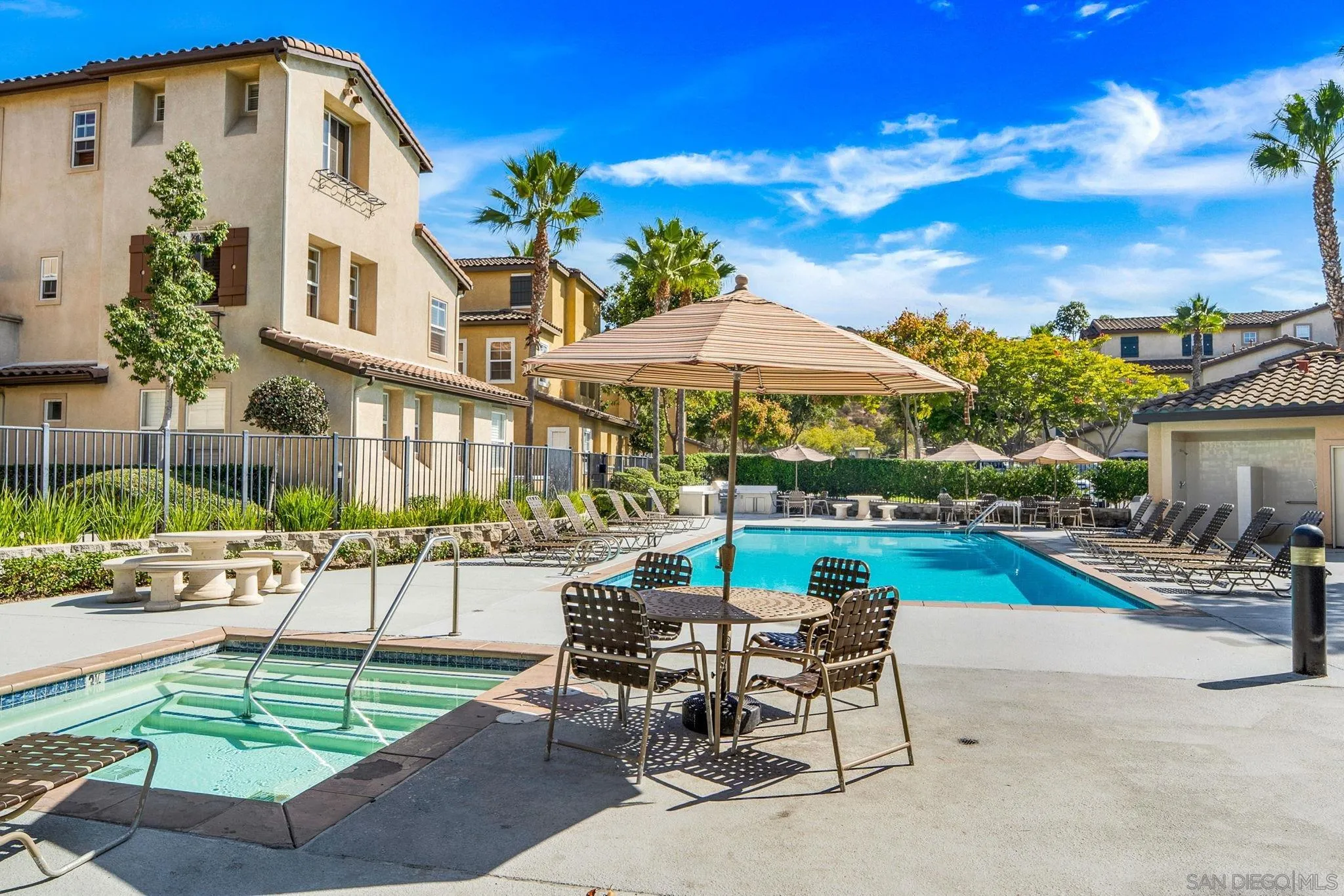 812 Compass Way San Diego, CA 92154 - Photo 31 of 39 a patio with a table and chairs under an umbrella