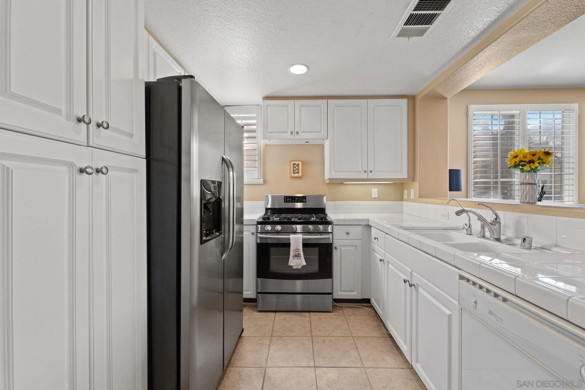 812 Compass Way San Diego, CA 92154 - Photo 5 of 39 a kitchen with stainless steel appliances granite countertop a refrigerator and a sink