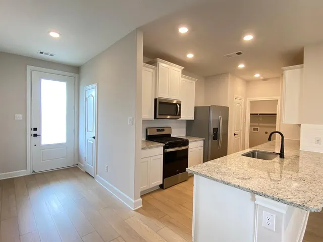 a kitchen with refrigerator and microwave