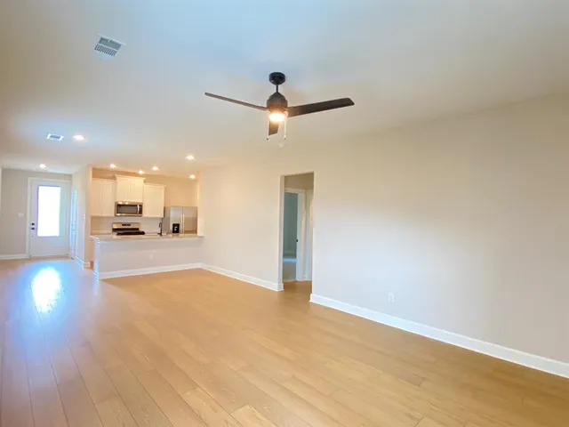 a view of a livingroom with a kitchen and a stove
