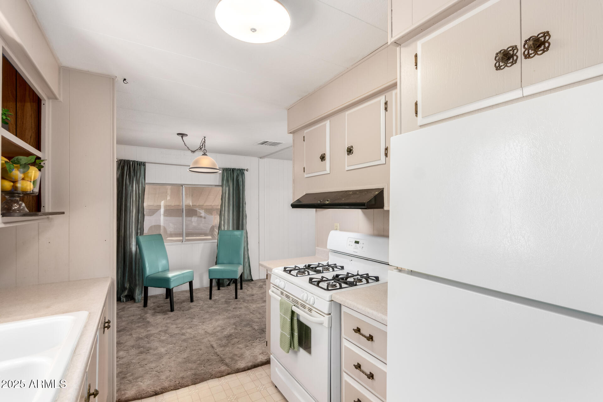 2700 East Allred Avenue, Unit R89 Mesa, AZ 85204 - Photo 10 of 28 a kitchen with stainless steel appliances a stove a sink and a refrigerator