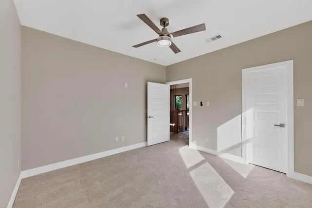 a view of a livingroom with a ceiling fan and window