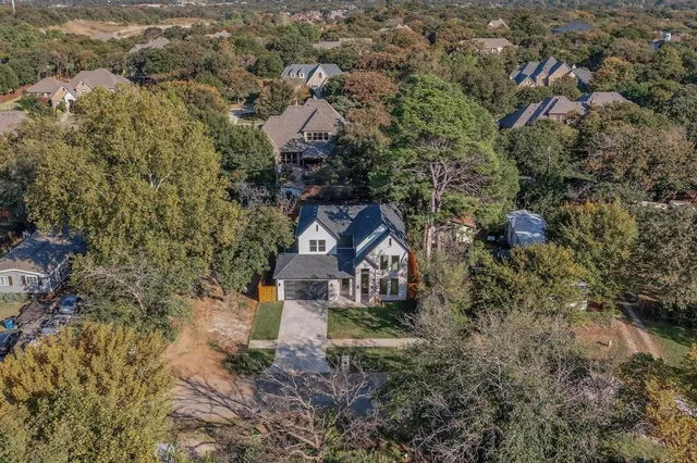 an aerial view of a house with a yard sitting space and garden view