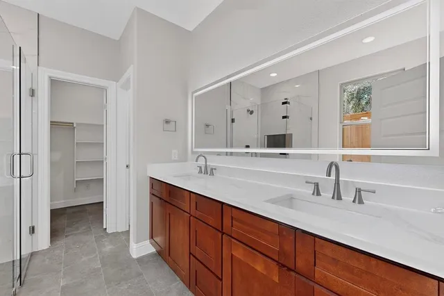 a bathroom with a double vanity sink mirror and