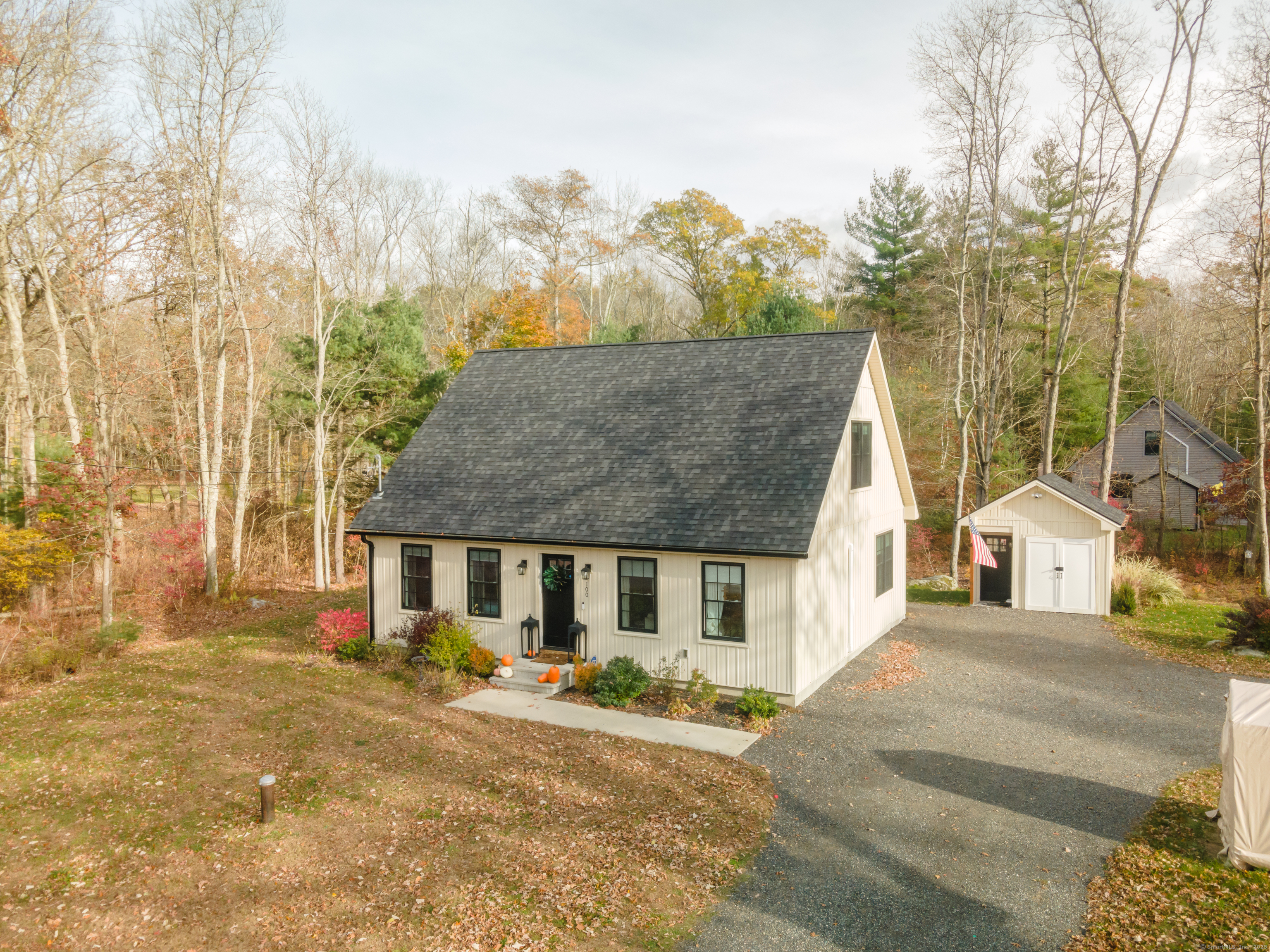 front view of a house with a large trees