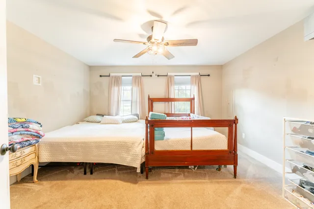 a bedroom with a bed table and window