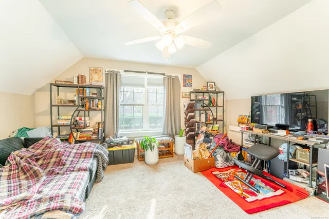 a living room filled with furniture and a floor to ceiling window